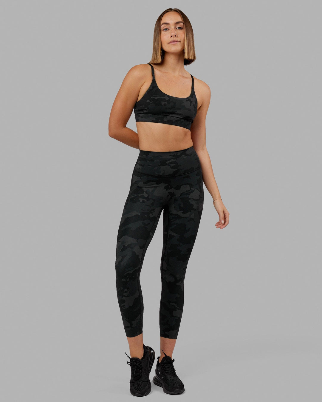Woman wearing Elixir Sports Bra - Black Camo