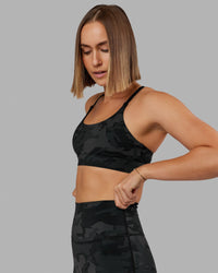 Woman wearing Elixir Sports Bra - Black Camo