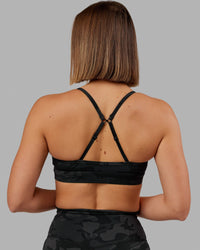 Woman wearing Elixir Sports Bra - Black Camo