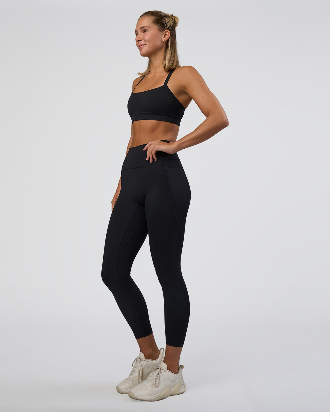 Woman wearing Fusion Ultra High-Rise 7/8 Legging Pockets - Black | Model:Amity | Size:S