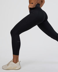 Woman wearing Fusion Ultra High-Rise 7/8 Legging Pockets - Black | Model:Amity | Size:S