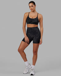 Woman wearing Fusion Ultra High-Rise 6" Short Pockets - Black Camo | Model:Katie | Size:S