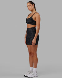 Woman wearing Fusion Ultra High-Rise 6" Short Pockets - Black Camo | Model:Katie | Size:S