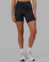 Woman wearing Fusion Ultra High-Rise 6" Short Pockets - Black Camo | Set:true | Angle:front | Model:Katie | Size:S