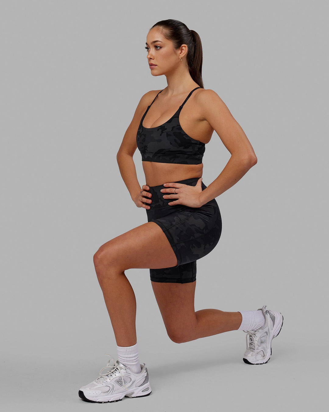 Woman wearing Fusion Ultra High-Rise 6" Short Pockets - Black Camo | Model:Katie | Size:S