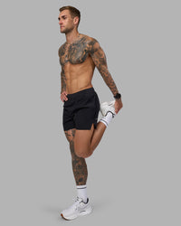 Man wearing Hybrid 5" Short - Black-Reflective | Model:Tommy | Size:S