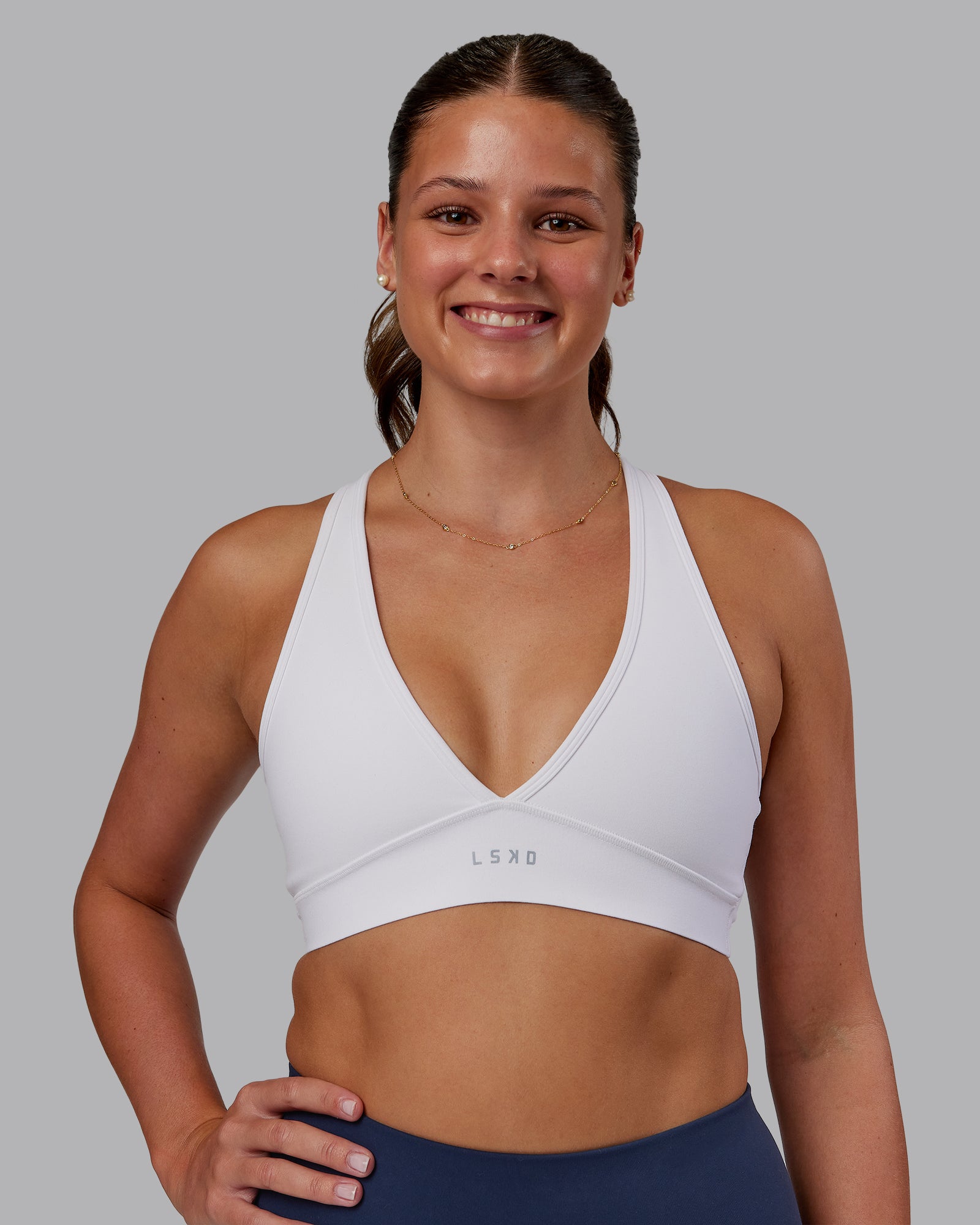 Woman wearing Stamina Sports Bra - White | Set:true | Angle:front | Model:Phoebe | Size:S