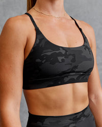 Woman wearing Elixir Sports Bra - Black Camo